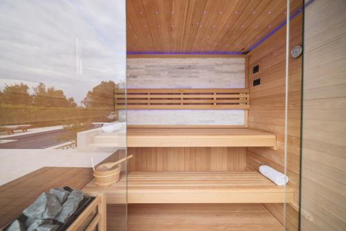 a sauna is shown with a glass wall at Villa Pino with Pool, Sauna & Jacuzzi in Petrcane