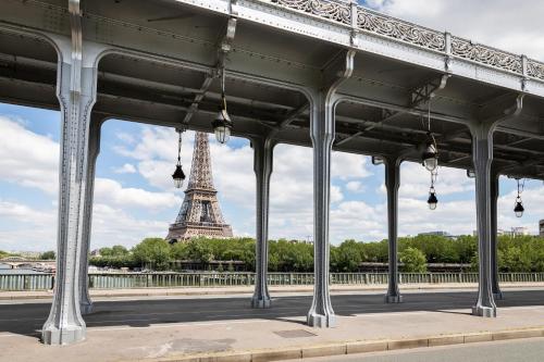 a view of the eiffel tower from under a bridge at Novotel Suites Paris Issy Les Moulineaux in Issy-les-Moulineaux