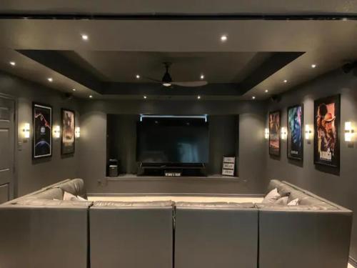 a waiting room with a large flat screen tv at Pool house with hot tub and cinema in Corinth