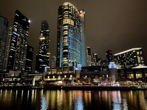 a view of a city at night with tall buildings at Morgan Place - Central Melbourne CBD Apartment on Flinders Lane Late Check-Out, Complimentary Welcome Hamper in Melbourne