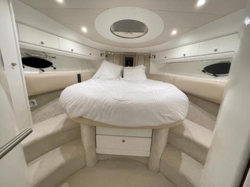 a bed in the middle of a boat with two sinks at Yacht 17M Cannes Croisette Port Canto,3 Ch,clim,tv in Cannes