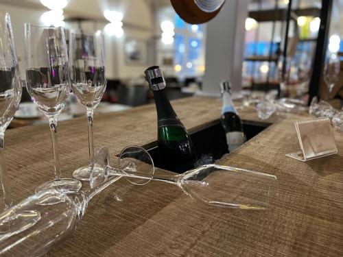a bunch of wine glasses sitting on a table at Hafen Hotel Schützenhof in Burg auf Fehmarn