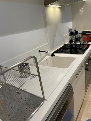 a kitchen with a stove and a white counter top at Appartement Anfa Park casa finance City CFC in Casablanca
