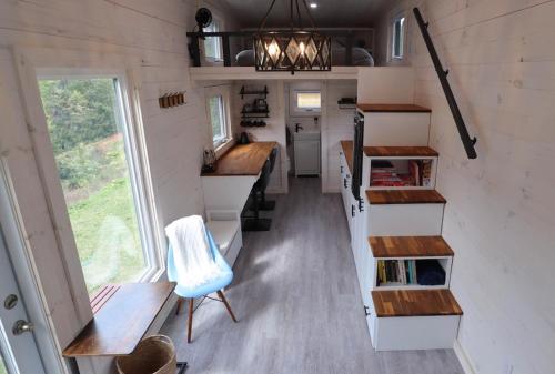 an interior view of a tiny house with a kitchen and stairs at Blue Bayou Resort, Cape Breton in Dingwall