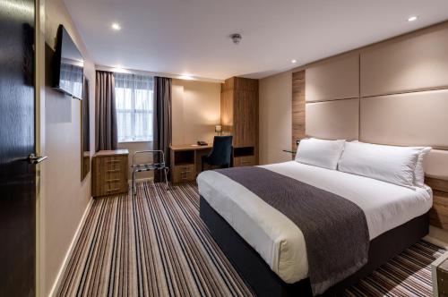 a hotel room with a bed and a desk at Holiday Inn York City Centre, an IHG Hotel in York
