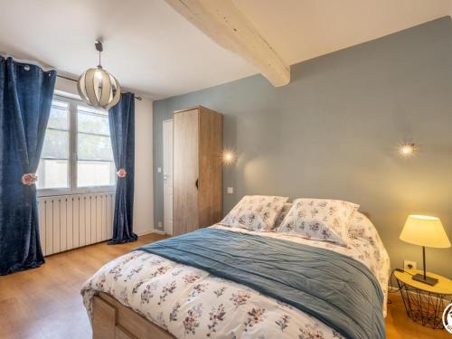 um quarto com uma cama com cortinas azuis e uma janela em Gîte Compiègne, 2 pièces, 2 personnes - FR-1-526-27 em Compiègne