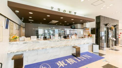 a restaurant with a counter in a building at Toyoko Inn Kagoshima chuo eki Nishi guchi in Kagoshima