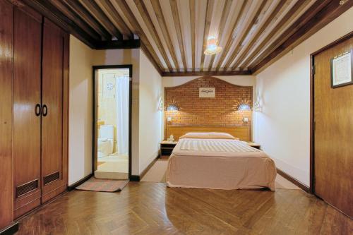 a bedroom with a bed in the middle of a room at Kantipur Temple House in Kathmandu