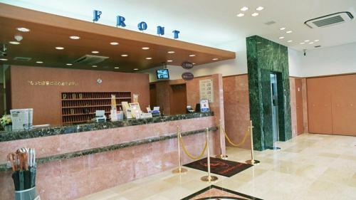 a lobby of a hotel with a reception counter at Toyoko Inn Miyazaki Chuo-dori in Miyazaki