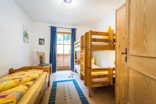 a bedroom with two bunk beds and a staircase at Bognerlehen in Berchtesgaden
