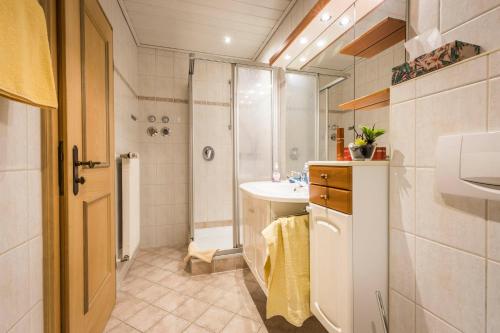 a small bathroom with a sink and a shower at Bognerlehen in Berchtesgaden