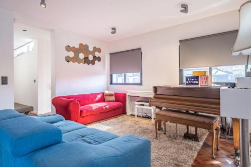 a living room with a couch and a piano at Casa Familiar 3 Quartos in Funchal