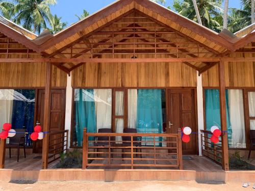 a house with a wooden roof at Lemon Grass Resort & Spa in Havelock Island