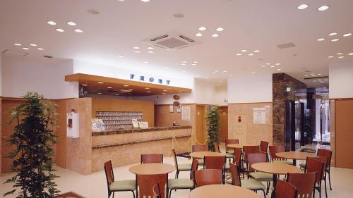 福岡的住宿－Toyoko Inn Hakata-eki Bus Terminal Mae，一间带桌椅和柜台的餐厅