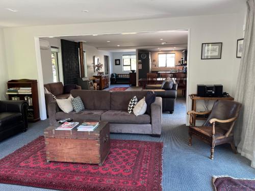 a living room with a couch and a table at Family Home on Inverness in Arrowtown