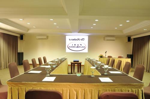 a large meeting room with a long table with chairs at The Residences at Puri Casablanca in Jakarta