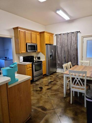 a kitchen with wooden cabinets and a table with a dining room at Chateau 15 in Hammond
