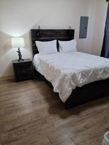a bedroom with a bed and a lamp on a table at Chateau 15 in Hammond