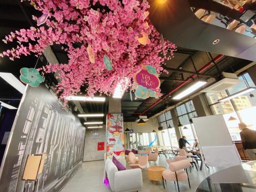 a room with pink flowers hanging from the ceiling at SOJO Hotel Hoa Binh in Hòa Bình