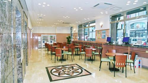 a restaurant with a bar and tables and chairs at Toyoko Inn Kumamoto-jyo Toricho Suji in Kumamoto