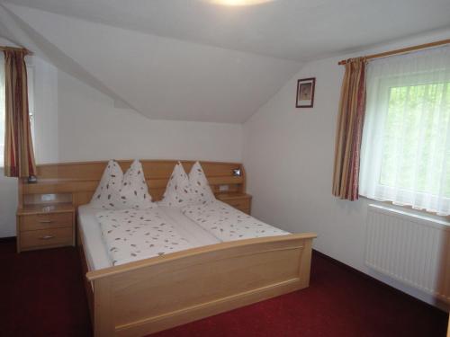 a bedroom with a bed and a window at Haus Toferer in Grossarl