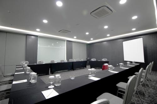 a conference room with a long table and chairs at Laska Hotel Subang in Subang