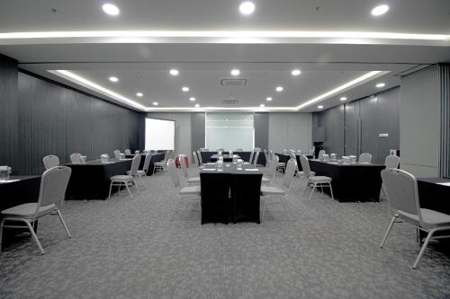 a conference room with tables and chairs in it at Laska Hotel Subang in Subang