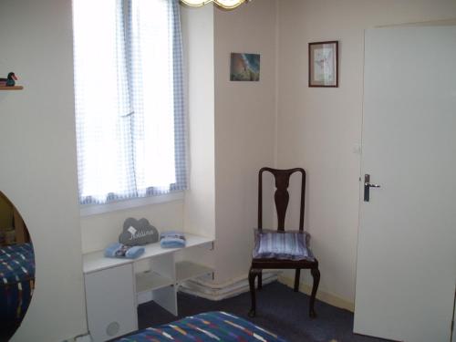 a room with a chair and a desk and a window at Rowland's French Retreat in La Rochebeaucourt-et-Argentine