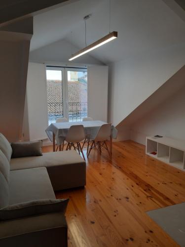 a living room with a couch and a table at São Bartolomeu Apartment 4 in Coimbra