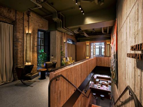 a lobby with a staircase in a building at Ace Hotel Sydney in Sydney