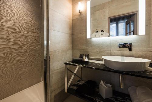 a bathroom with a sink and a mirror at LE PETIT MANOIR in Sarlat-la-Canéda