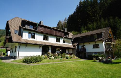 a large house with a grass yard in front of it at Gummeneck - Stubenhof, Black Forest in Simonswald