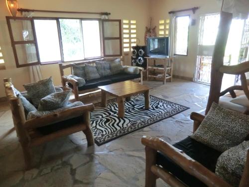 a living room with couches and a coffee table at Marula Park in Diani Beach