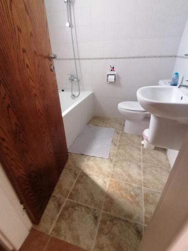 a bathroom with a sink and a tub and a toilet at Spacious 3 bedroom villa private pool in Paphos