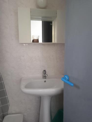 a bathroom with a sink and a mirror at Antonia Rooms in Skála Foúrkas