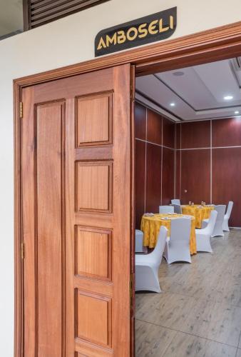 a door leading into a dining room with a table at Verona Hotel and Conference Center in Ruiru