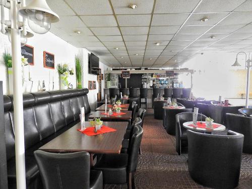 a dining room with tables and black chairs at Apartement zum Kuckuck noch mal in Hohegeiß