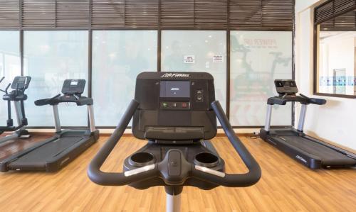a gym with three treadying machines in a room at Verona Hotel and Conference Center in Ruiru