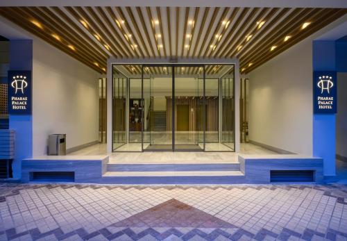 a lobby with a large glass door in a building at Pharae Palace in Kalamata