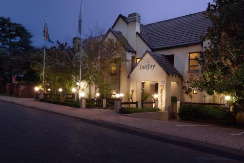a building with lights on the side of a street at InnJoy Boutique Hotel in Centurion