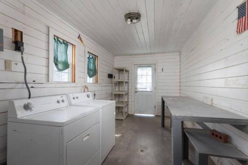 a kitchen with a washing machine and a table at Summer Deal! Grand Performance Home in Downtown Fort Worth Stockyard, Globe Life, AT&T in Fort Worth