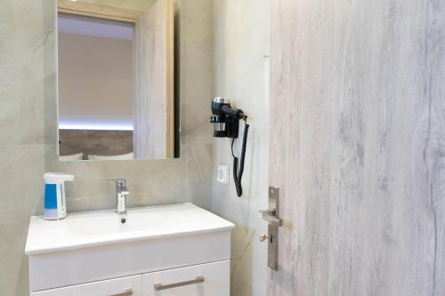 a bathroom with a sink and a mirror at Gramvoussa Bay in Kissamos
