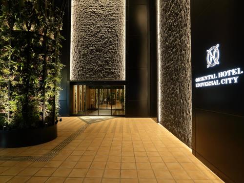 a lobby of a hotel with a sign on the wall at ORIENTAL HOTEL UNIVERSAL CITY in Osaka