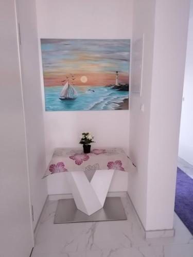 a table in a room with a painting on the wall at Vila Slavica in Vir