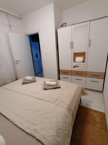 a bedroom with a large bed and white cabinets at Vila Slavica in Vir