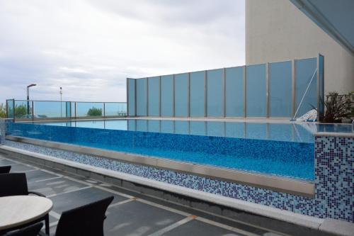a swimming pool on the roof of a building at Hotel Columbus in Lignano Sabbiadoro