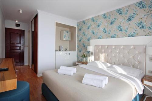 a large white bed with two pillows on top of it at Vidikovac Budva in Budva