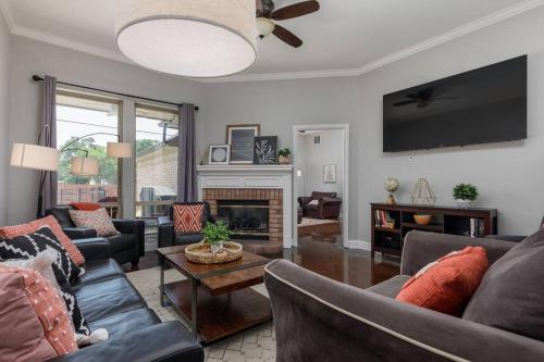 a living room with two couches and a fireplace at Large Executive Family Home with Pool near DFW Airport in Keller
