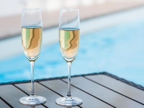 two glasses of champagne sitting on top of a table at Okinawa EXES Naha in Naha