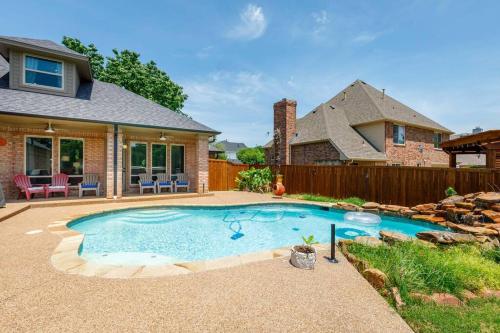 a swimming pool in the backyard of a house at Large Executive Family Home with Pool near DFW Airport in Keller
